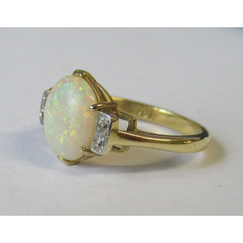 333 - An 18ct opal and diamond ring, the central oval cabochon, with four old cut diamonds to the shoulder... 