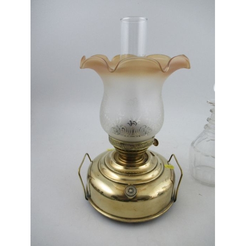 346 - An oil lamp and three decanters