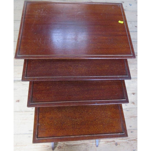 37 - A nest of four mahogany tables, of rectangular form raised on ring turned legs, 22ins x 15ins, heigh... 