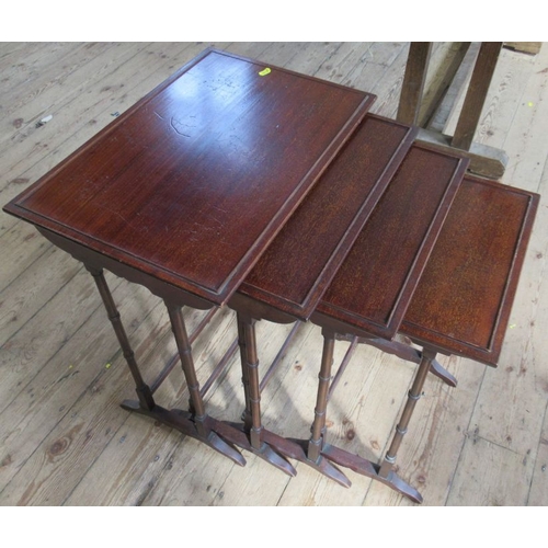 37 - A nest of four mahogany tables, of rectangular form raised on ring turned legs, 22ins x 15ins, heigh... 