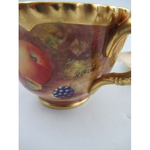 382 - A Royal Worcester cabinet cup and saucer, decorated with hand painted fruit, signed N.Creed