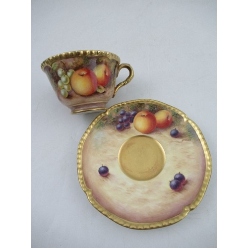 383 - A Royal Worcester cabinet cup and saucer, decorated with hand painted fruit, signed N.Creed