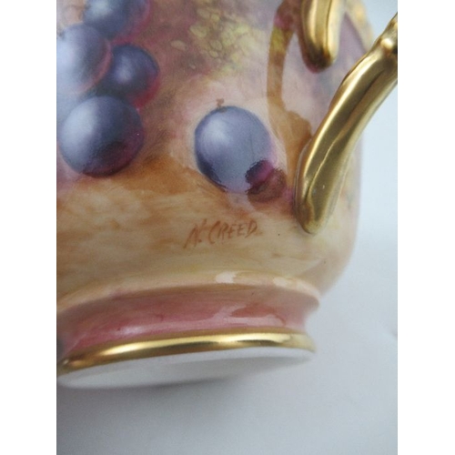 384 - A Royal Worcester cabinet cup and saucer, decorated with hand painted fruit, the cup, signed N.Creed... 