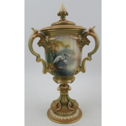 387 - A Royal Worcester after Hadley covered vase, having three handles, decorated with panels of storks b... 