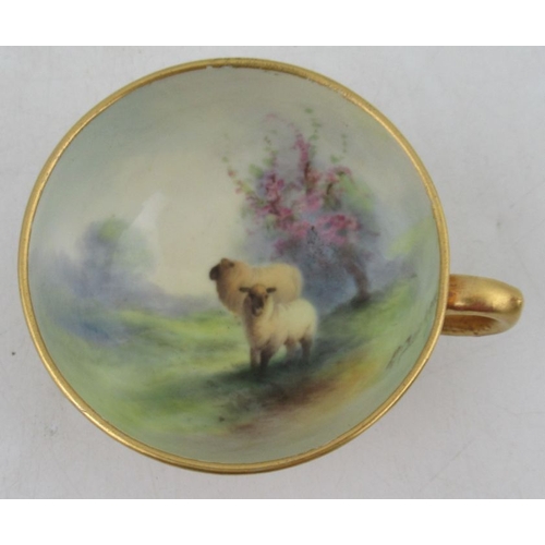 398 - A Royal Worcester miniature tea cup and saucer, the saucer and the interior of the cup decorated wit... 