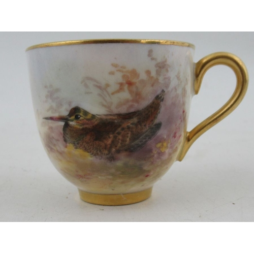 401 - A Royal Worcester miniature coffee cup and saucer, cup decorated with a wood Cock, saucer decorated ... 