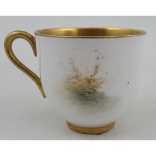 402 - A Royal Worcester miniature coffee cup and saucer, both the cup and saucer decorated with sheep in l... 