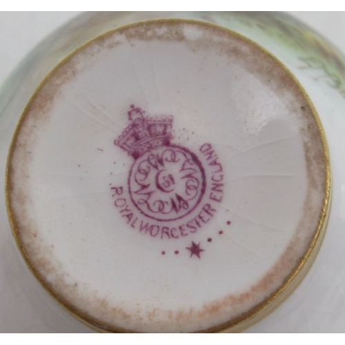 402 - A Royal Worcester miniature coffee cup and saucer, both the cup and saucer decorated with sheep in l... 