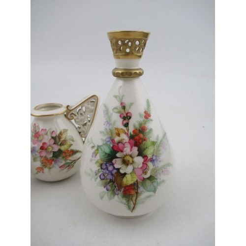 410 - A Royal Worcester vase,  decorated with hand painted flowers to a white ground, with a pierced rim, ... 