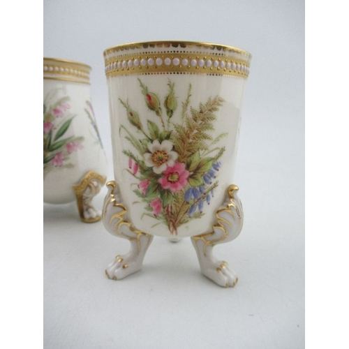 416 - A pair of Royal Worcester vases, decorated with floral sprays, with jewelled decoration, raised on t... 