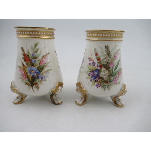 416 - A pair of Royal Worcester vases, decorated with floral sprays, with jewelled decoration, raised on t... 