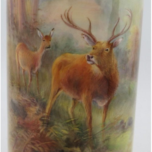 420 - A Royal Worcester cylindrical vase, decorated with stag and a hind in landscape by Harry Stinton, to... 