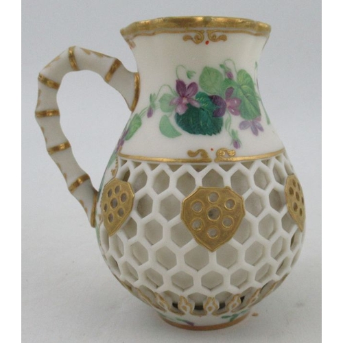 429 - A Kerr & Binns Worcester reticulated jug, decorated with painted flowers and a bird, height 4ins