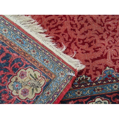 78 - An Eastern design rug, with red field and blue ground lozenges, 87ins x 54ins