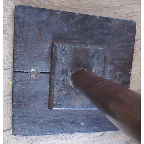 13 - A 17th century primitive yew wood and oak candle stand, the square oak top supported by a turned yew... 