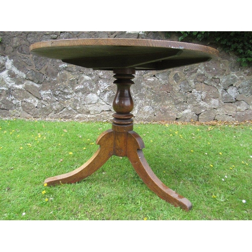 20 - An oak tripod table diameter 35ins height 28ins