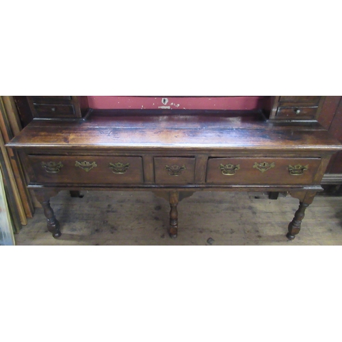 40 - An Antique dark oak dresser, the open back with shelves and cupboards, the base fitted with drawers,... 