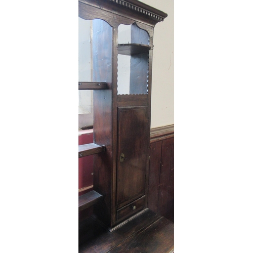 40 - An Antique dark oak dresser, the open back with shelves and cupboards, the base fitted with drawers,... 