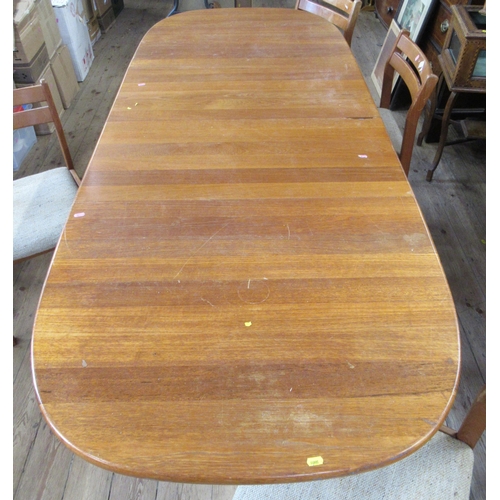 50 - A mid century teak extending dining table, with 2 extra leaves, together with a set of four dining c... 