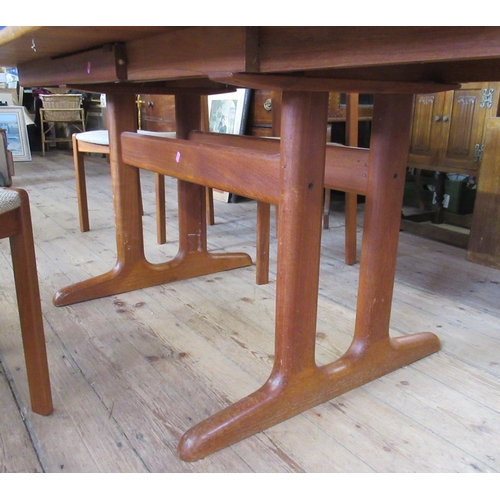 50 - A mid century teak extending dining table, with 2 extra leaves, together with a set of four dining c... 