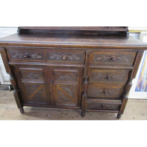 1 - A Welsh style oak dresser, with shelves to the rack back, fitted with a cupboard and drawers with ca... 