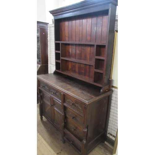 1 - A Welsh style oak dresser, with shelves to the rack back, fitted with a cupboard and drawers with ca... 