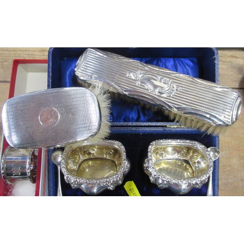 108 - A cased pair of silver salts, with spoons, together with a napkin rings and two silver backed brushe... 