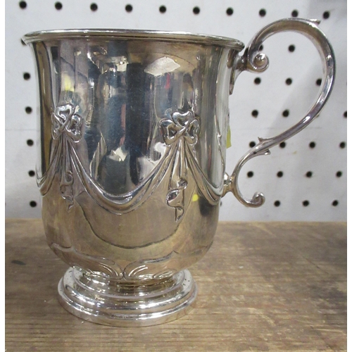 113 - A silver mug, with swag decoration, raised on a circular foot, weight 5oz