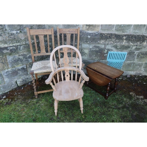 14 - A child's Windsor arm chair together with two cane seated chairs and an occasional table