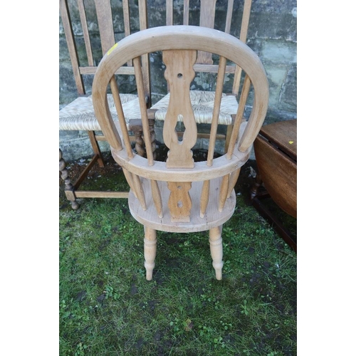 14 - A child's Windsor arm chair together with two cane seated chairs and an occasional table