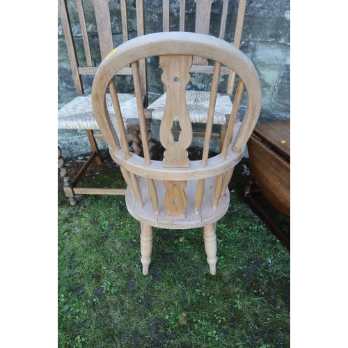 14 - A child's Windsor arm chair together with two cane seated chairs and an occasional table