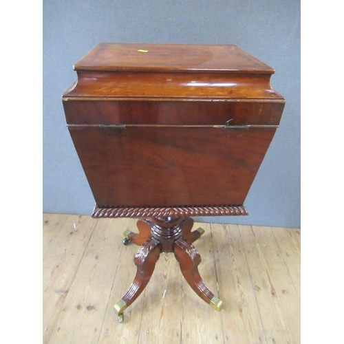 16 - A Regency mahogany cellarette / teaboy, the top opening to reveal compartments raised on turned colu... 