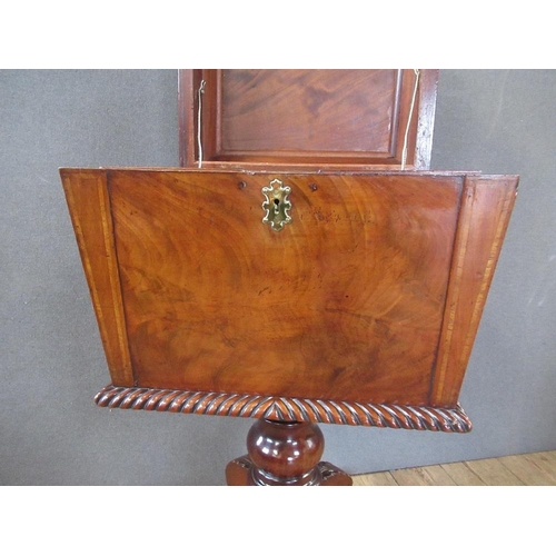 16 - A Regency mahogany cellarette / teaboy, the top opening to reveal compartments raised on turned colu... 