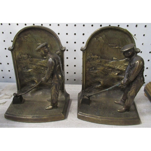 169 - A pair of bronze bookends, modelled with golfers