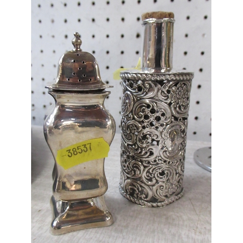 175 - A silver pepper pot, together with a pierced silver bottle cover