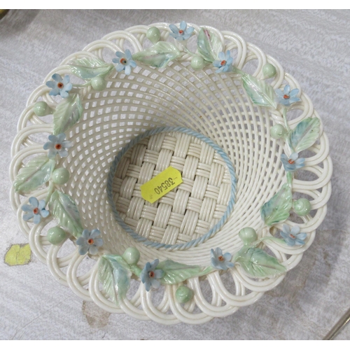 177 - A Belleek porcelain basket weave bowl, decorated with coloured flowers, diameter 6ins, height 2.5ins