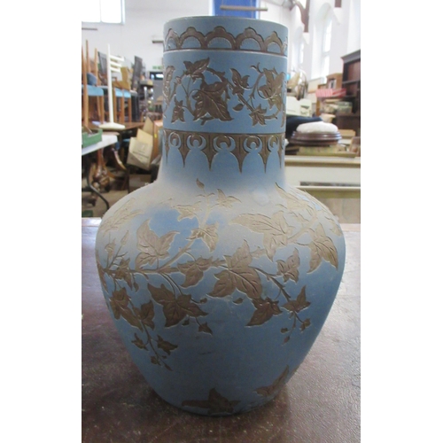 209 - A Victorian Langley Ware vase, decorated with ivy to a blue ground, dated 1889, height 13ins (36285)