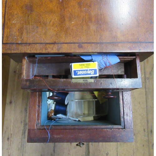 21 - A 19th century mahogany work table, with drop flaps, drawer and material covered basket, on turned l... 