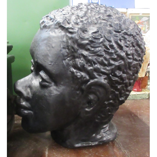 232 - V Hackett, 1962, a black pottery bust of a man, height 10ins