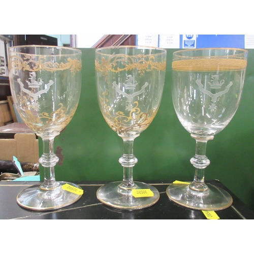 234 - Three drinking glass, each with different gilt decoration and etched with the same crest