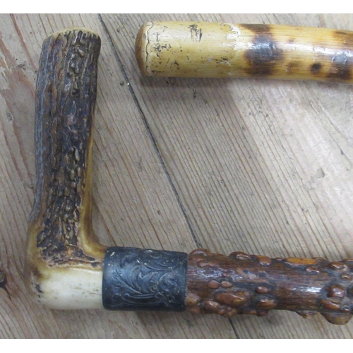 235 - A Victorian horn handled walking stick, with silver collar, together with another stick