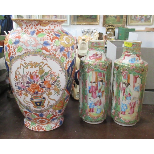 237 - A pair of Oriental cylindrical vases, decorated with panels of birds and figures, height 10ins, toge... 