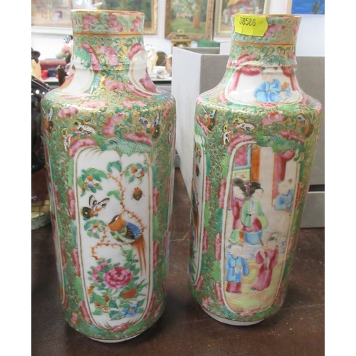 237 - A pair of Oriental cylindrical vases, decorated with panels of birds and figures, height 10ins, toge... 