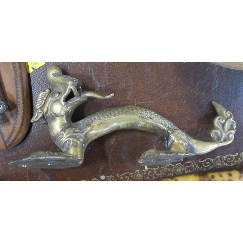 239 - A brass door handle, modelled as a dragon, together with a door knocker modelled as an elephant