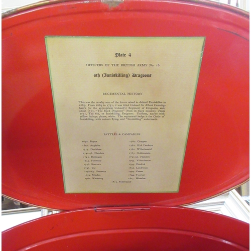 24 - Two red metal bins, one with lid, both with prints of 6th Inniskilling Dragoons, together with anoth... 