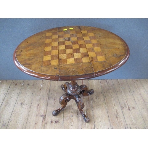 40 - A 19th century walnut games table raised on turned column, terminating in four outswept feet, width ... 