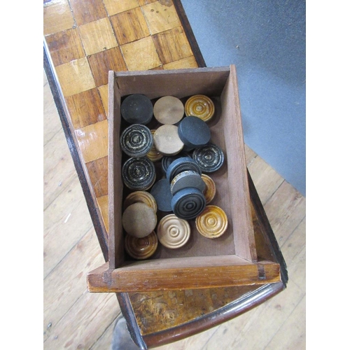 40 - A 19th century walnut games table raised on turned column, terminating in four outswept feet, width ... 