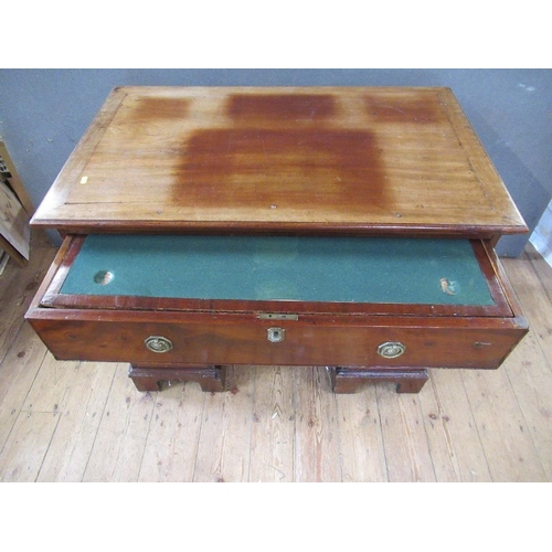 48 - A 19th century mahogany desk, having raising top with ratcheted support, the drawer opening to revea... 