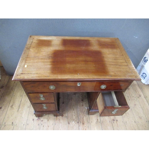 48 - A 19th century mahogany desk, having raising top with ratcheted support, the drawer opening to revea... 