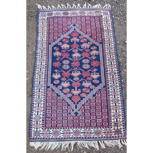 62 - An Eastern design rug, 55ins x 33ins